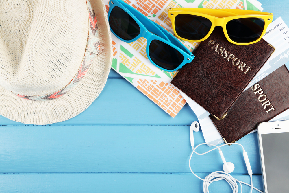flat lay of travel documents - travel insurance